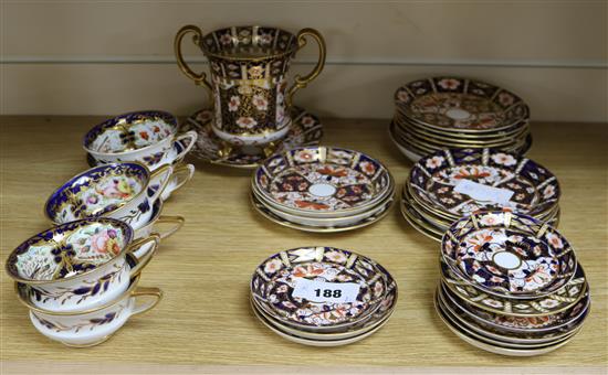A large quantity of Royal Crown Derby Imari style patterned plates, saucers and a two-handled base with similar cups